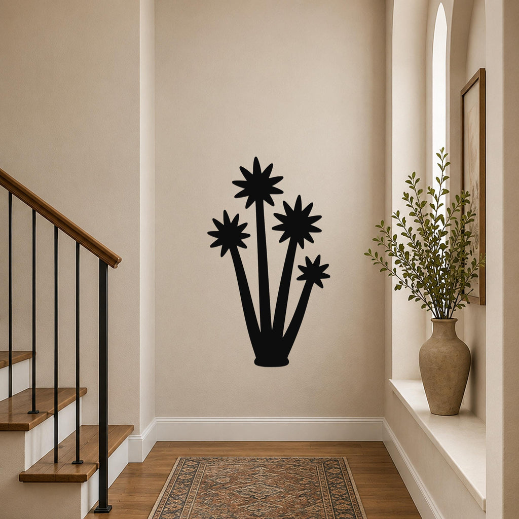 Black metal yucca wall art with star-shaped flower cutouts, mounted on a hallway wall above a patterned rug near a staircase.
