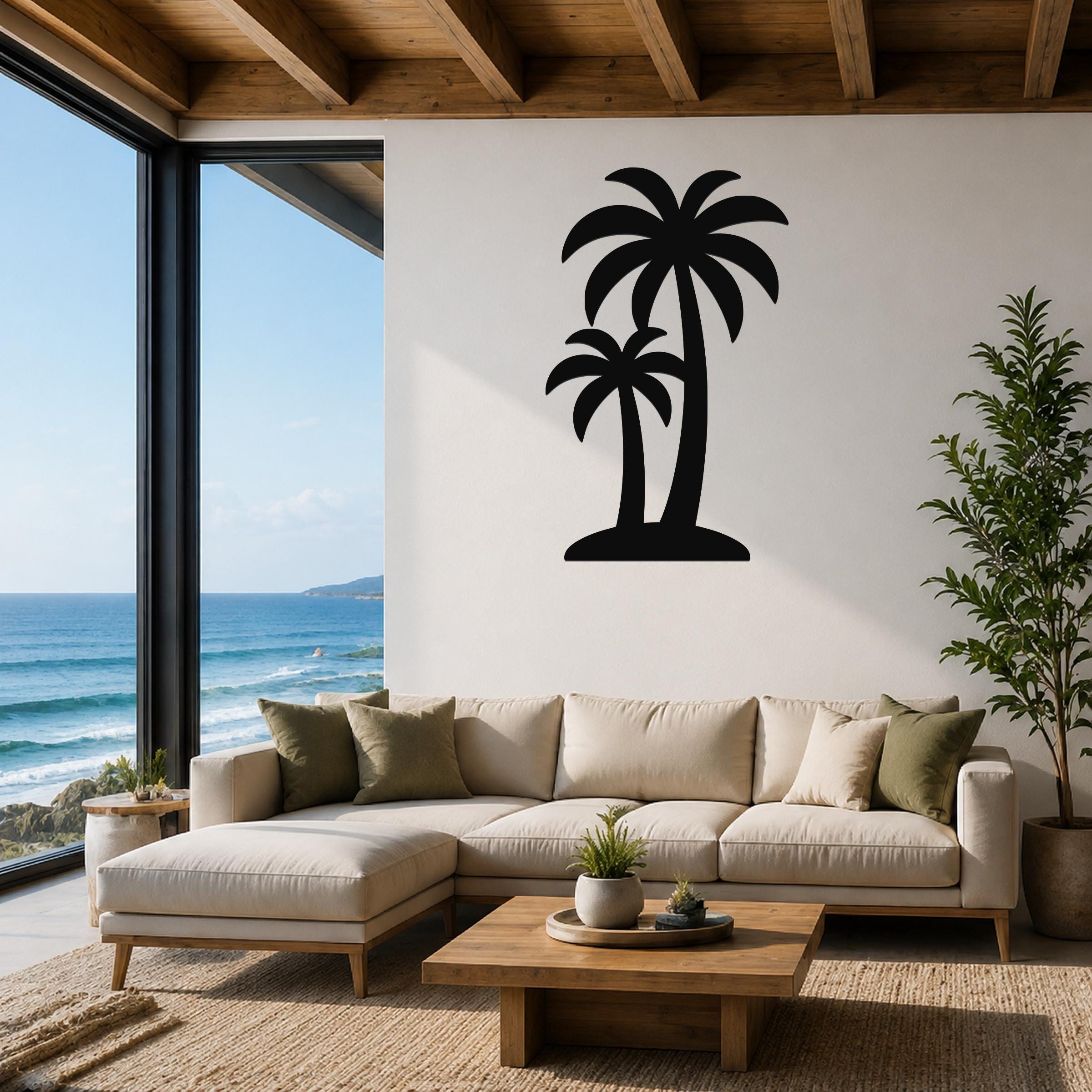 Black metal twin palm tree wall art silhouette mounted on a living room wall above a beige sectional sofa.