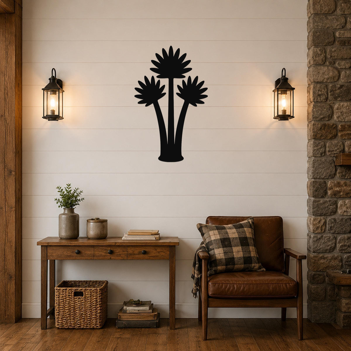 Black metal wall art featuring a silhouette of three fan palm trees, mounted on a shiplap wall above a wooden console table in a living room.