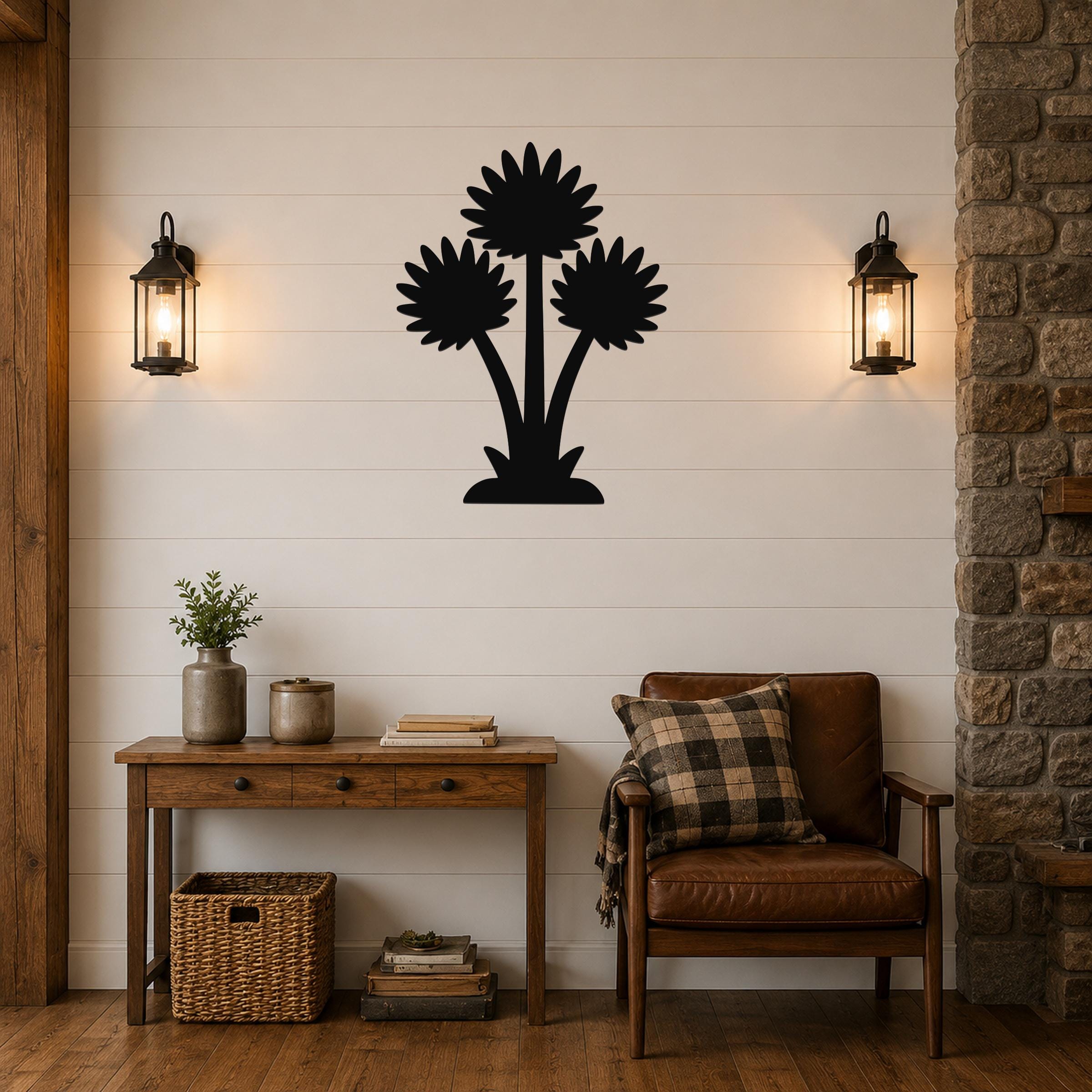Black metal wall art with a silhouette of three wildflowers, mounted on a shiplap wall above a wooden console table in a living room.