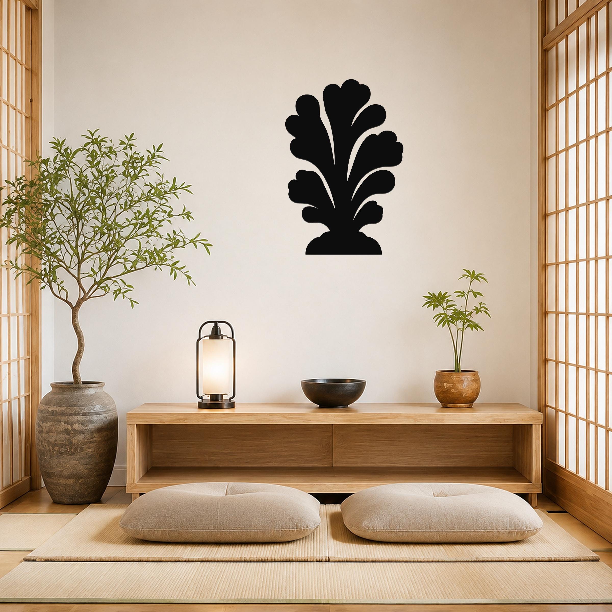 Black metal wall art in a coral silhouette design, mounted on a living room wall above a wooden console table.