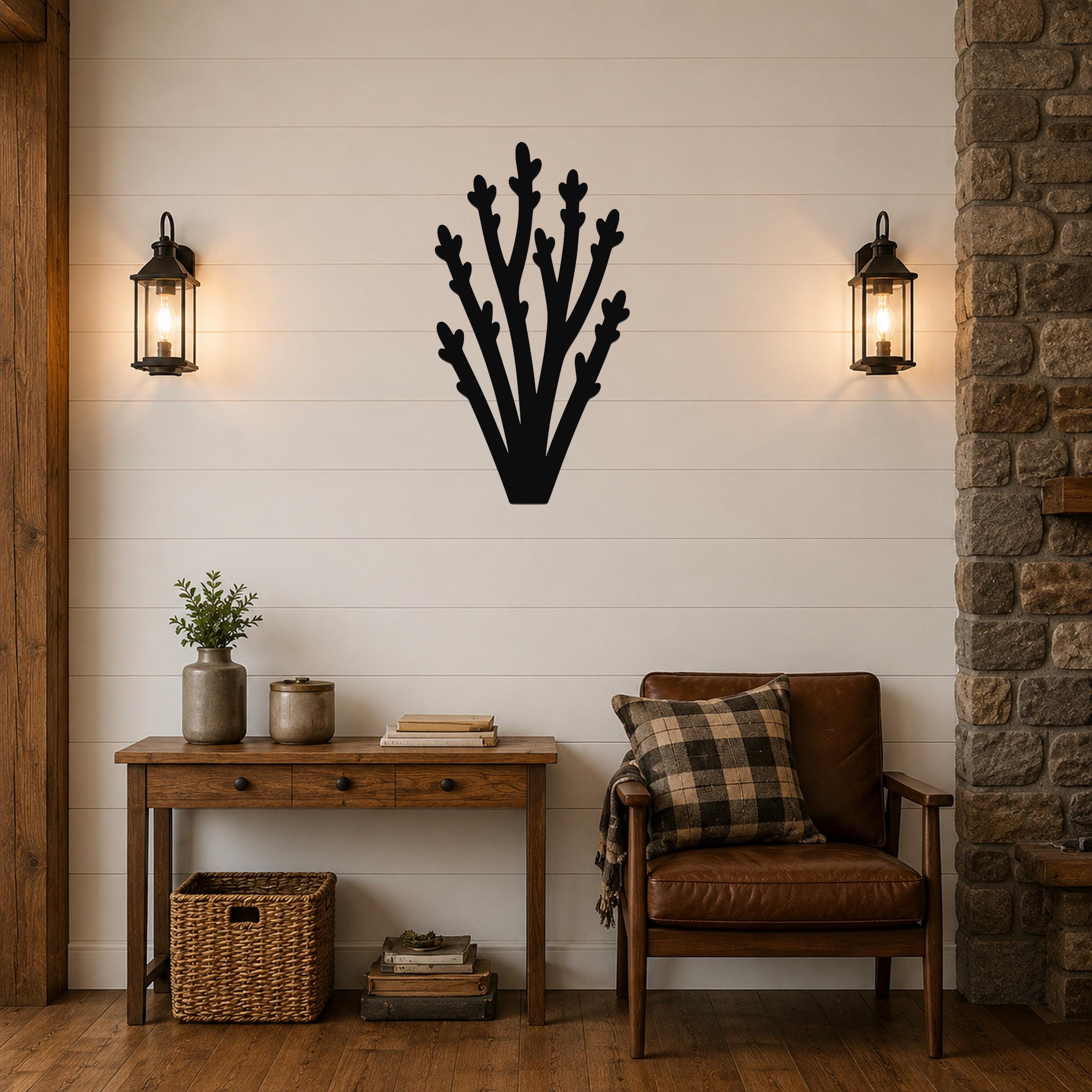 Black metal wall art in a desert branch silhouette, mounted on a shiplap wall above a wooden console table in a living room.