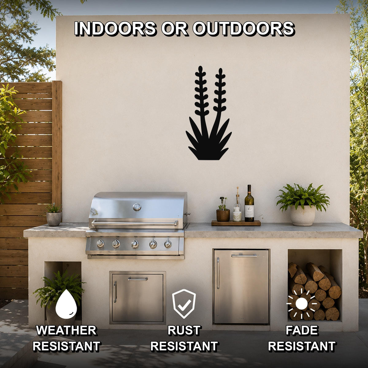 Black metal yucca wall art silhouette mounted on an outdoor kitchen wall above a stainless steel grill, with visible cutout details of spiky leaves and stems.