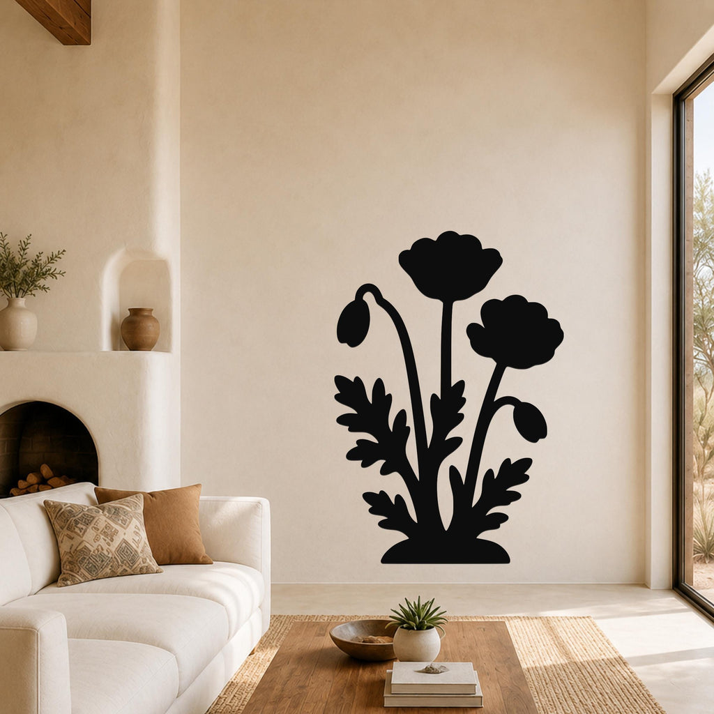 Black metal wall art with a floral silhouette of three poppies and leaves, mounted on a living room wall above a sofa.