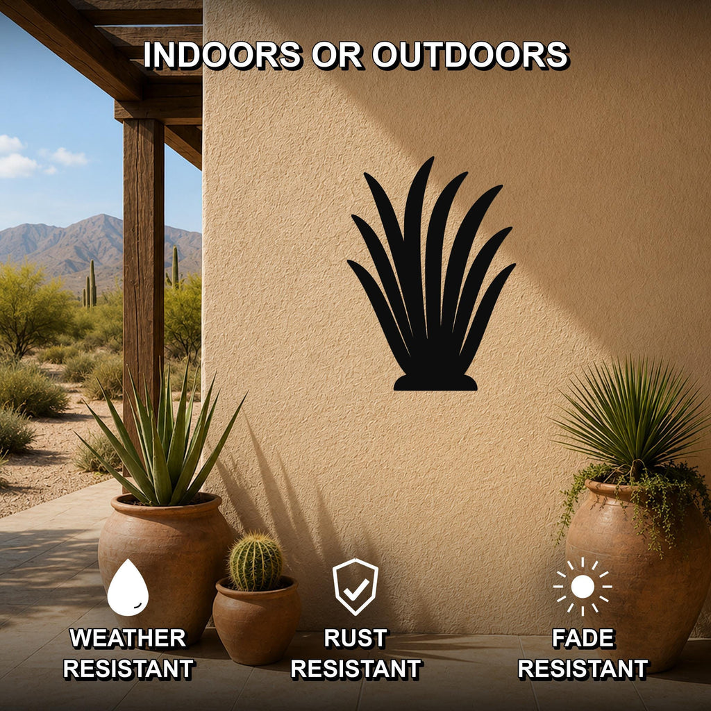 Black metal agave wall art silhouette mounted on a beige outdoor wall, displayed on a patio with potted plants and desert scenery in the background.