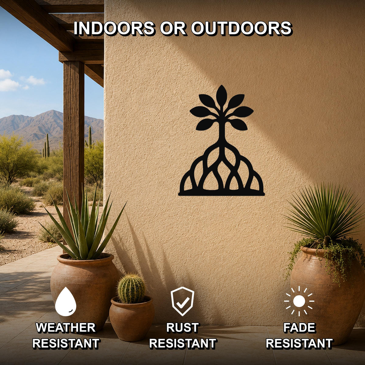 Black metal wall art in a rooted tree silhouette with leaf and root cutouts, mounted on an outdoor stucco wall above potted plants on a patio.
