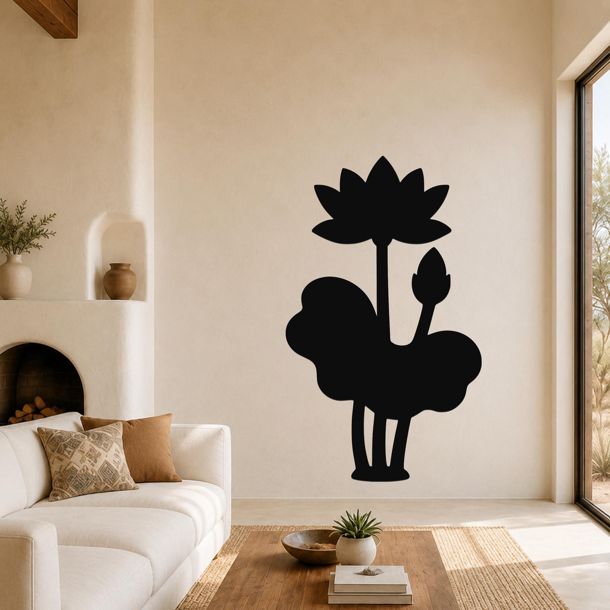 Black metal wall art silhouette of a lotus flower and leaves, mounted on a living room wall above a sofa.