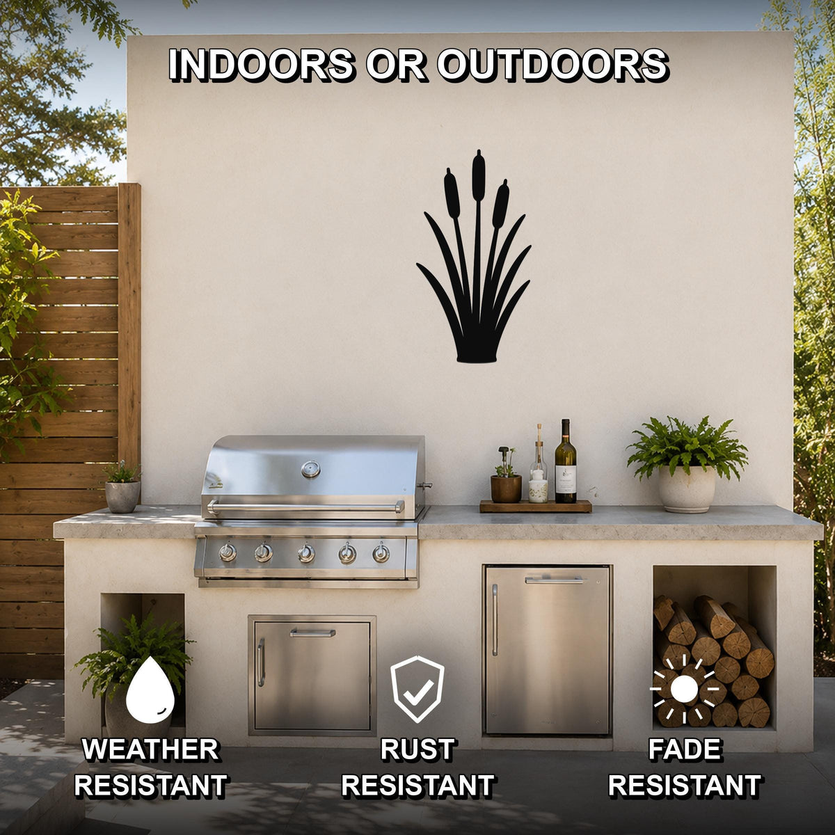 Black metal cattail wall art silhouette mounted on an outdoor patio wall above a stainless steel grill and countertop, with visible weather, rust, and fade resistance icons.