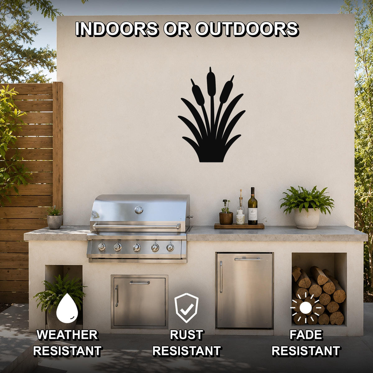 Black metal cattail wall art silhouette mounted on an outdoor patio wall above a stainless steel grill and counter.