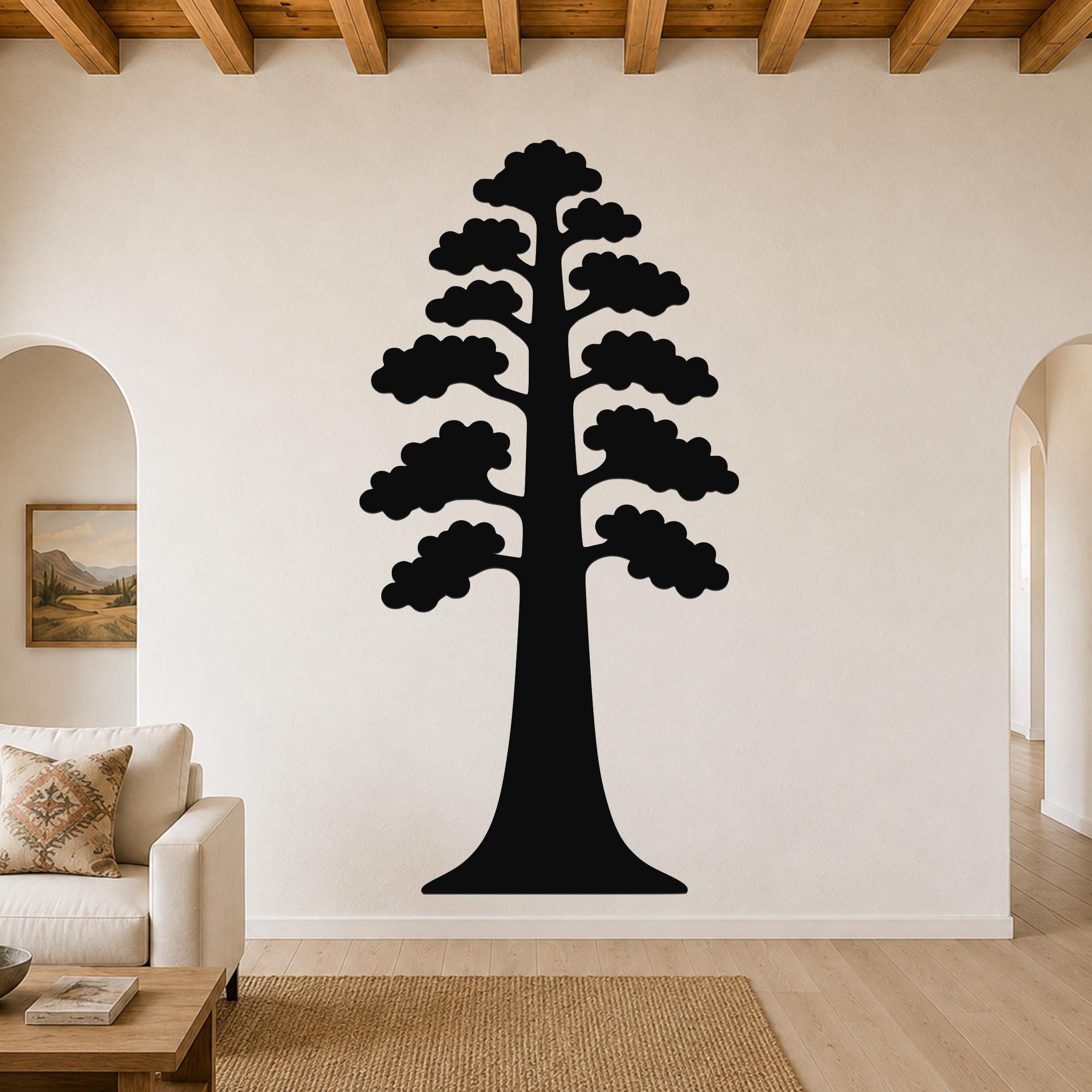 Black metal wall art of a sequoia tree silhouette with layered branches, mounted on a living room wall above a sofa.