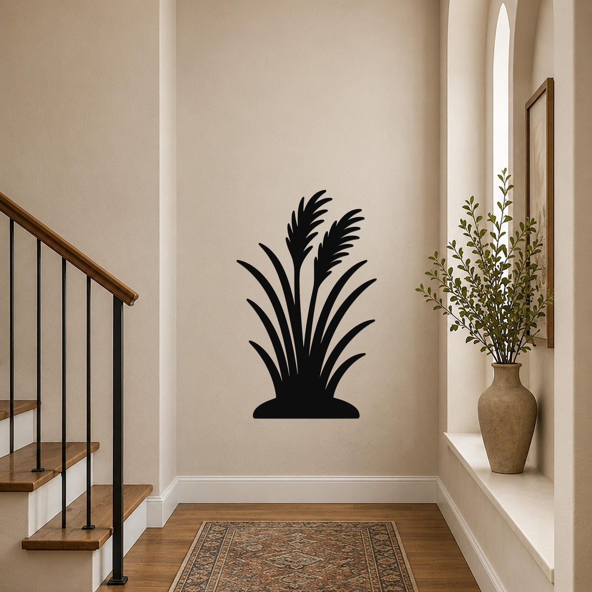Black metal wall art in a wild grass silhouette design, mounted on a hallway wall above a patterned rug near a staircase.