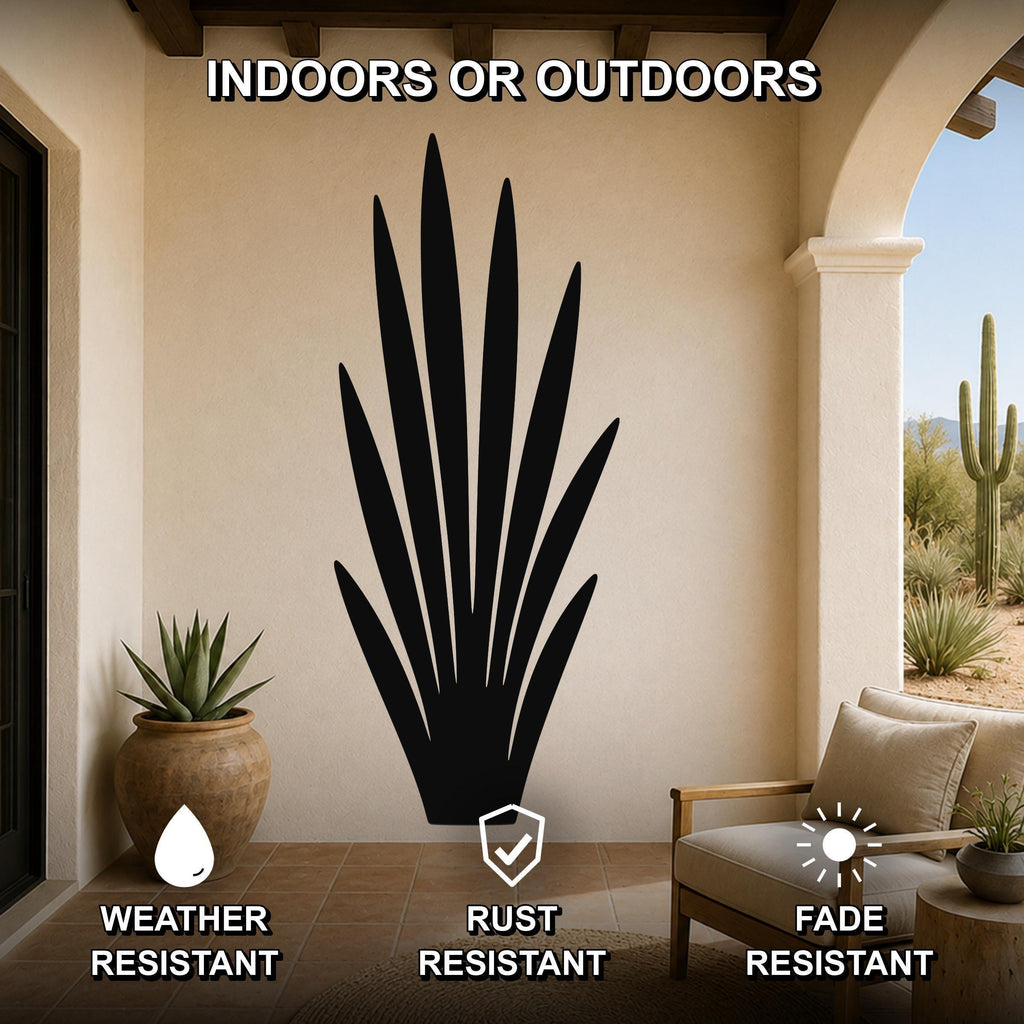 Black metal agave wall art silhouette with spiky leaves, mounted on a beige patio wall above a chair, weather resistant, rust resistant, and fade resistant.
