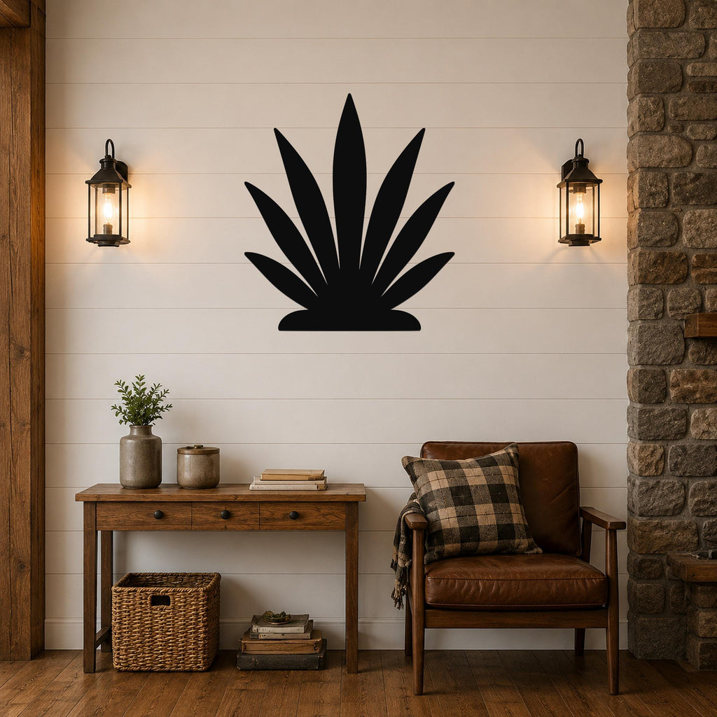 Black metal agave wall art silhouette mounted on a shiplap wall above a wooden console table in a living room.