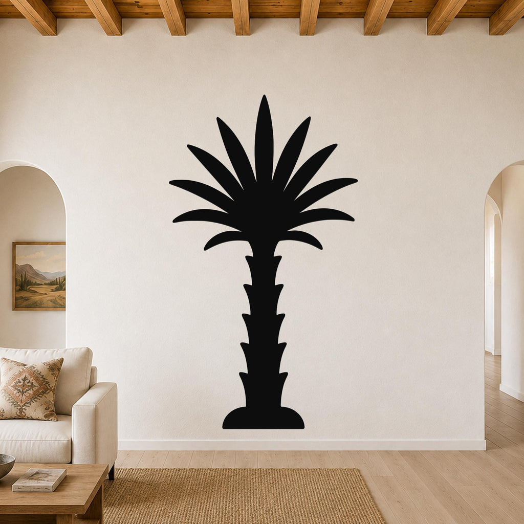 Black metal palm tree wall art silhouette mounted on a living room wall above a sofa, with arched doorways and wooden beams visible.