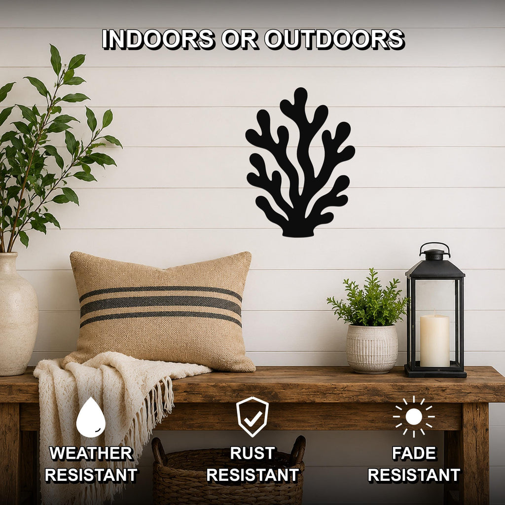 Black metal coral wall art with branching cutouts, mounted on a white shiplap wall above a wooden bench in a living room.