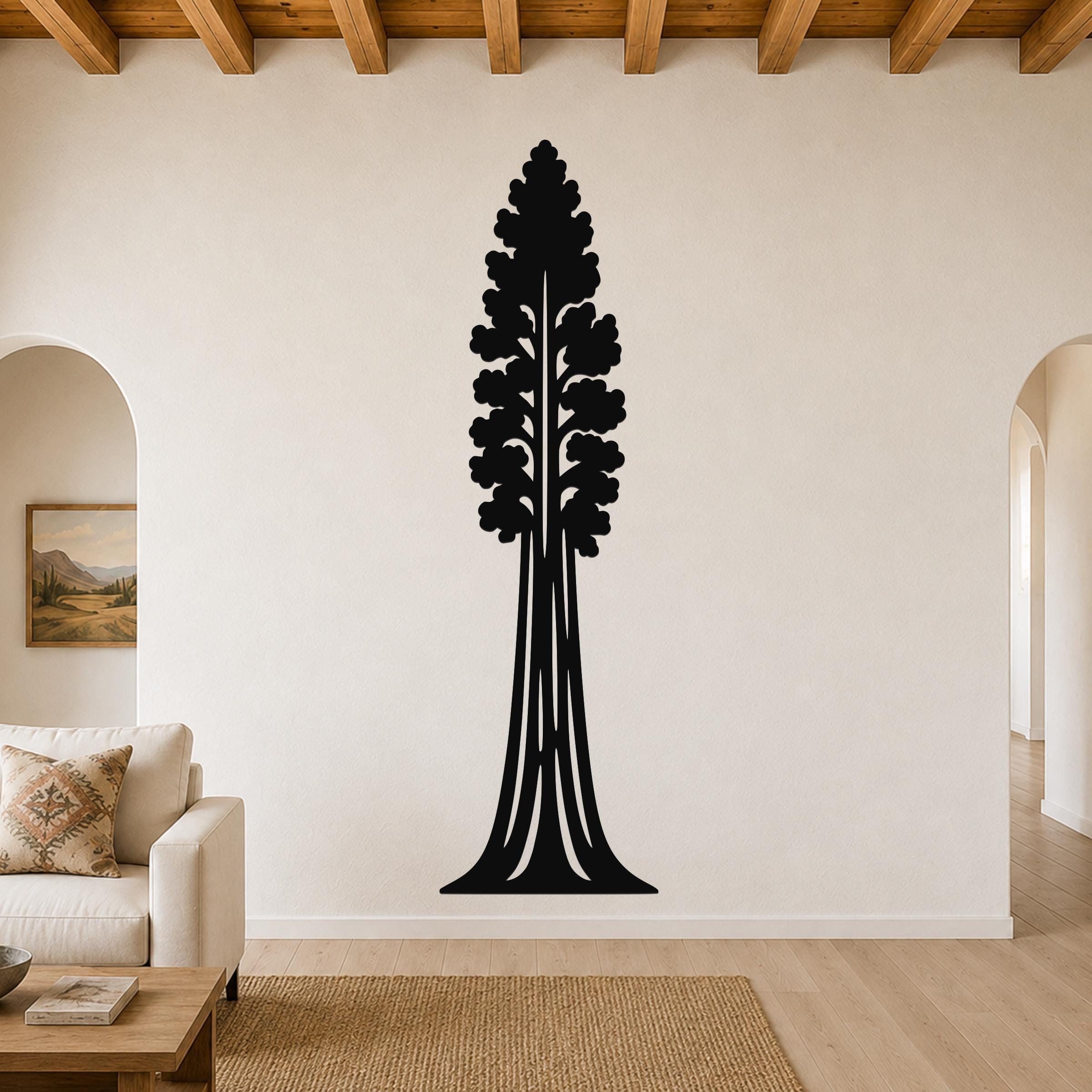 Black metal wall art of a sequoia tree silhouette with layered branch cutouts, mounted on a living room wall above a sofa.