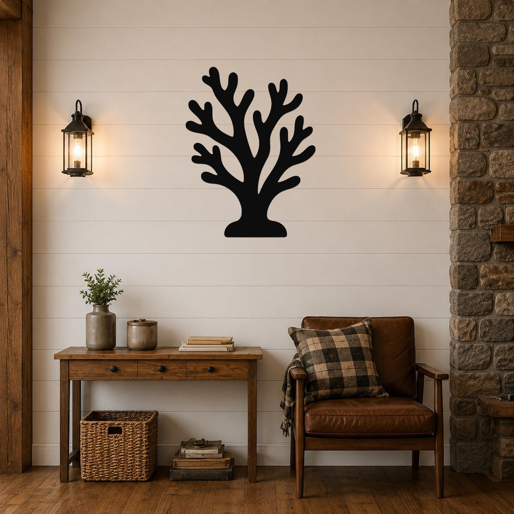 Black metal coral wall art with branching cutouts, mounted on a beige hallway wall near a staircase and a potted plant.