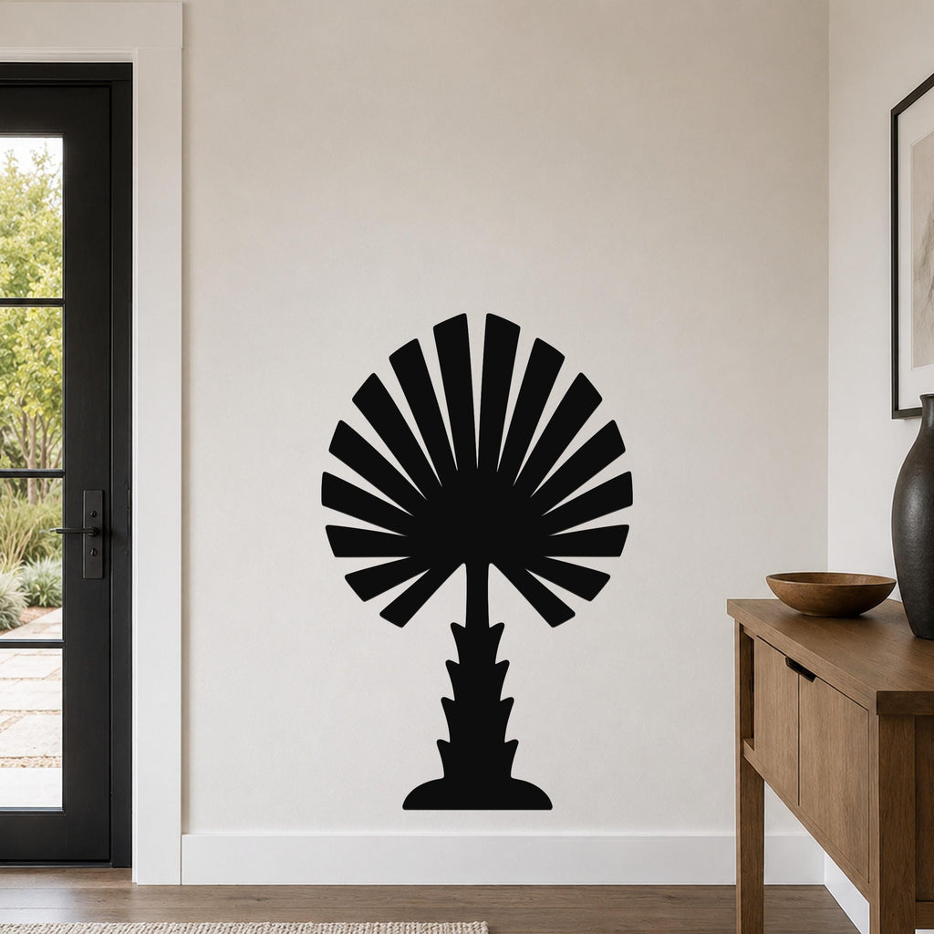 Black metal palm tree wall art with fan-shaped fronds, mounted on a living room wall above a wooden console table.