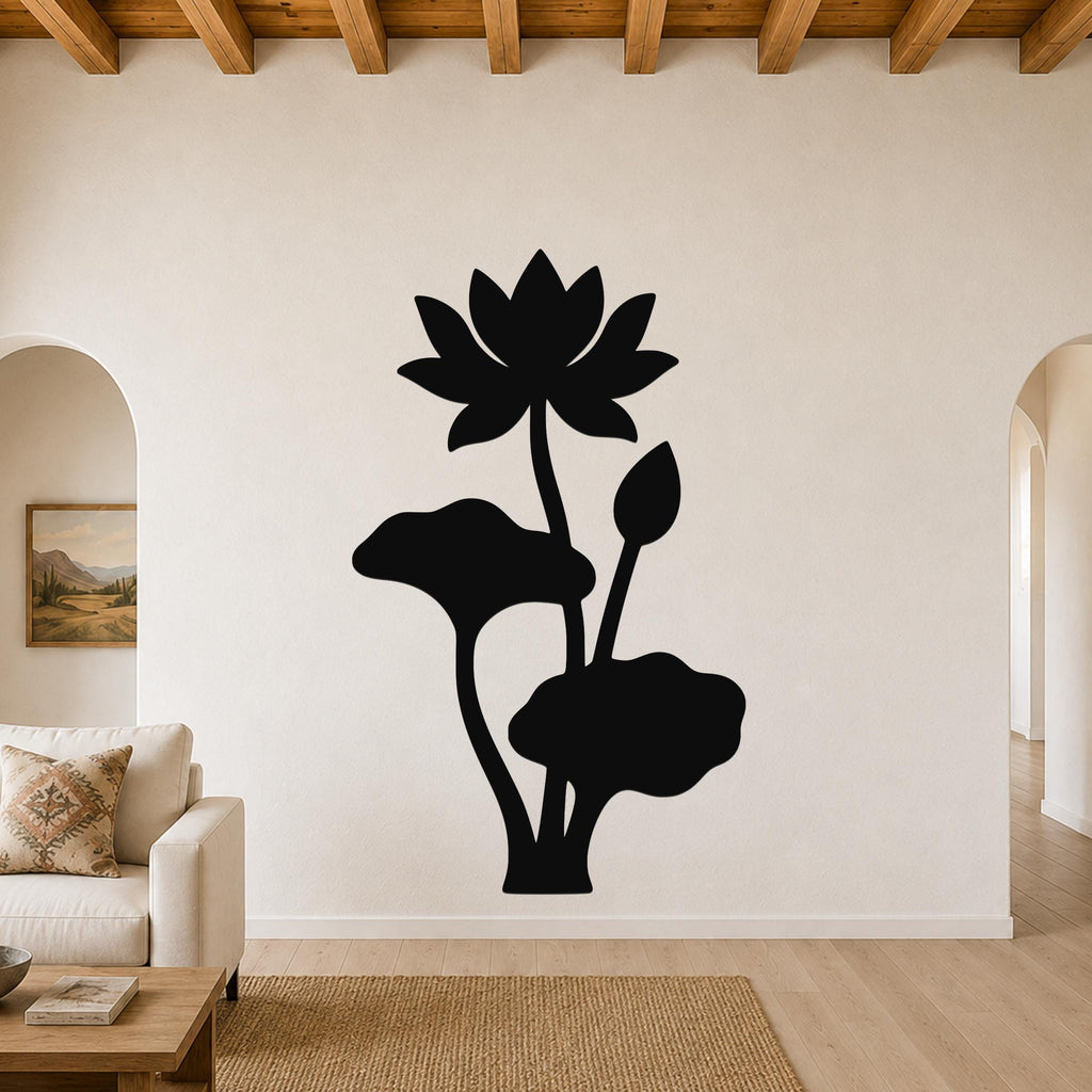 Black metal lotus wall art with a silhouette of a blooming flower, leaves, and a bud, mounted on a living room wall above a sofa.