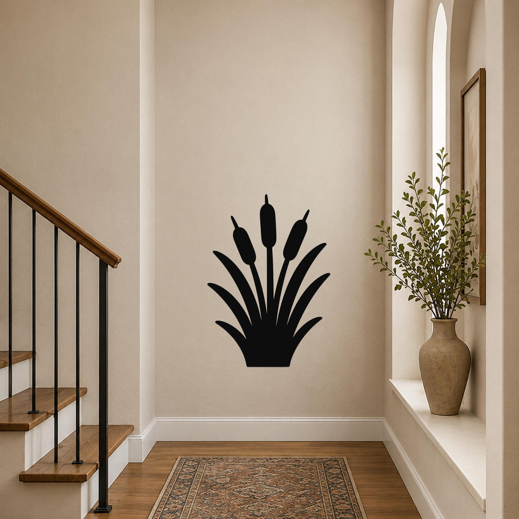 Black metal cattail wall art silhouette with three seed heads, mounted on a hallway wall above a patterned rug near a staircase.