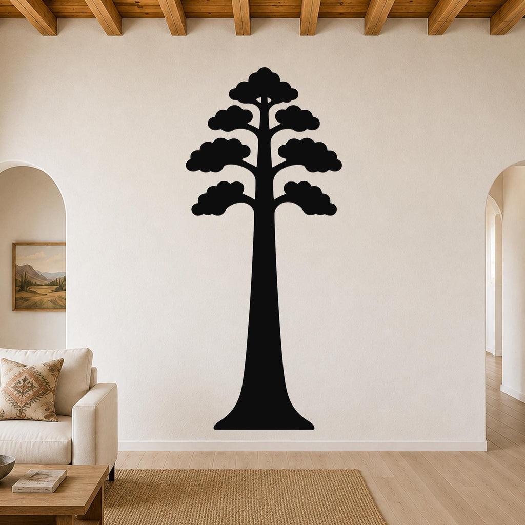 Black metal sequoia tree wall art with layered canopy cutouts, mounted on a living room wall above a sofa.