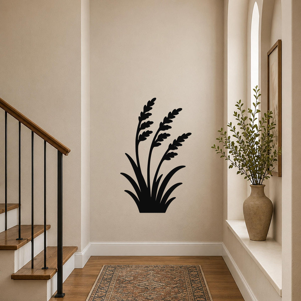 Black metal wall art in a wild grass silhouette design, mounted on a hallway wall above a patterned rug near a staircase.