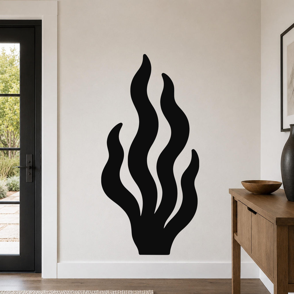 Black metal kelp wall art with flowing seaweed cutouts, mounted on a white wall in a modern entryway.