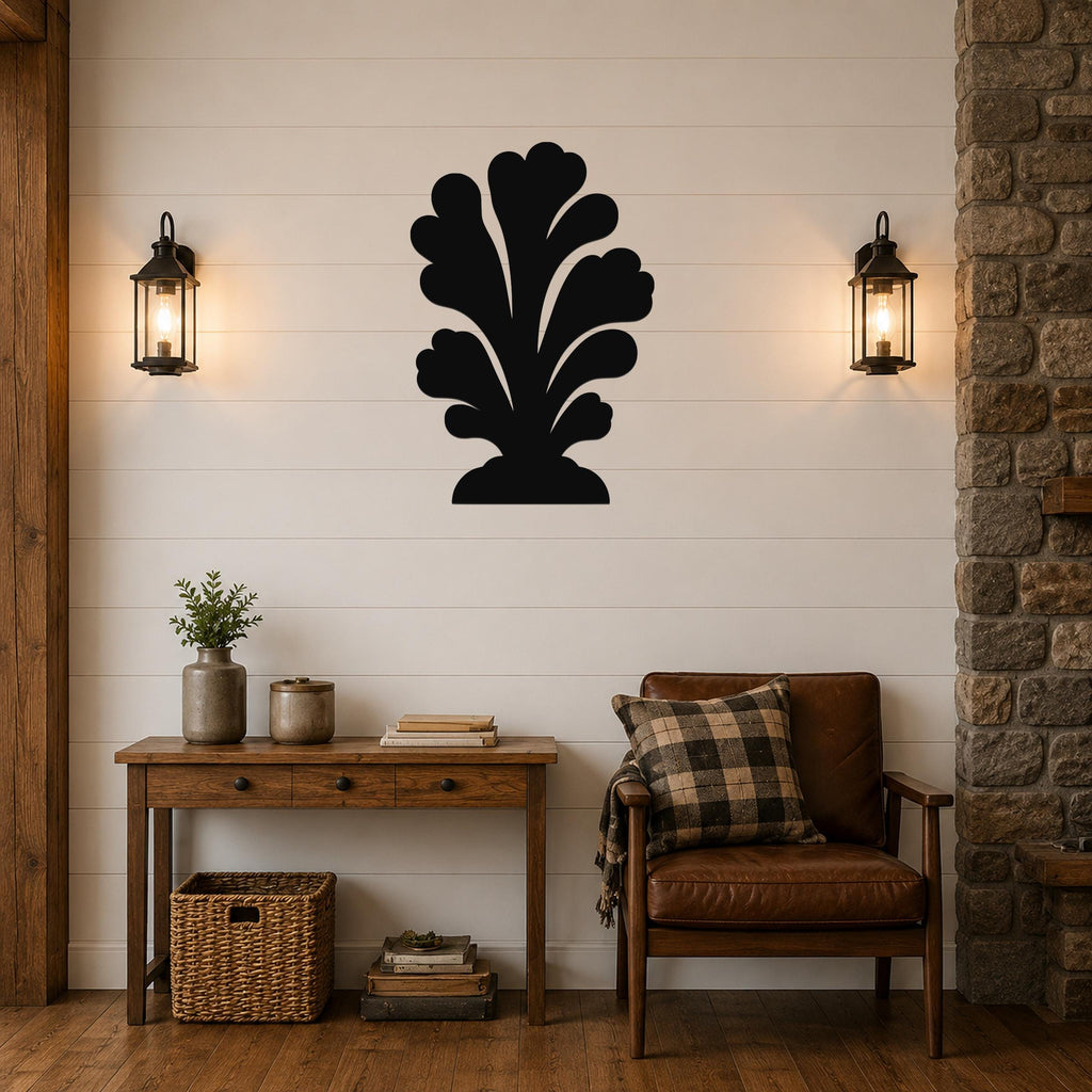 Black metal wall art in a coral or leaf-like silhouette, mounted on a shiplap wall above a wooden console table in a living room.