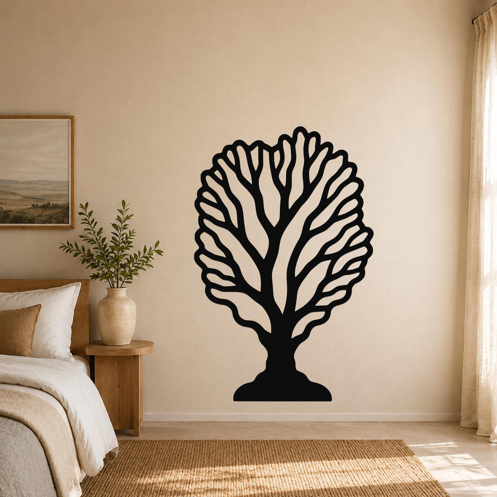Black metal fan coral wall art with intricate branch cutouts, mounted on a beige bedroom wall above a woven rug.