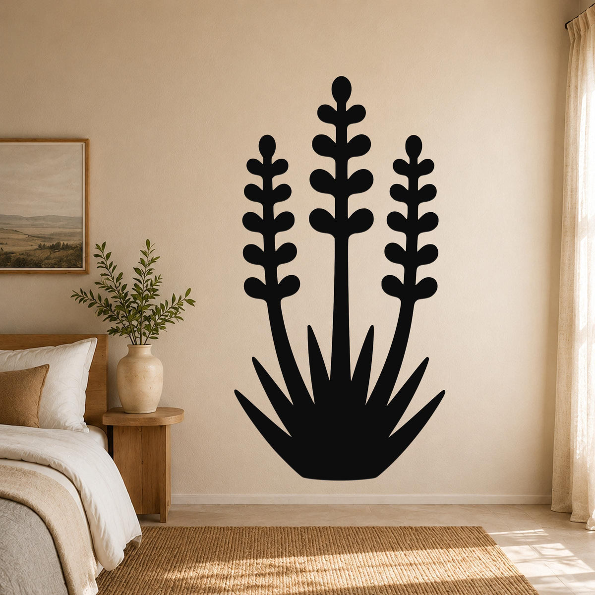 Black metal wall art in a yucca plant silhouette with three tall stems and spiky base, mounted on a beige bedroom wall above a woven rug.