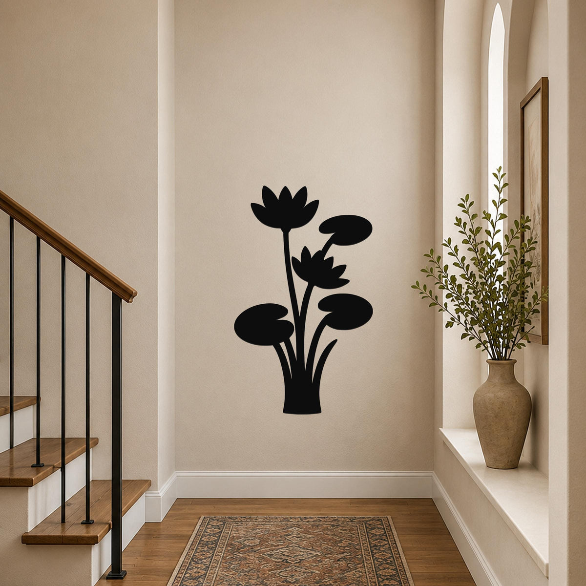 Black metal lotus water lily wall art with flower and leaf cutouts, mounted on a hallway wall above a patterned rug.