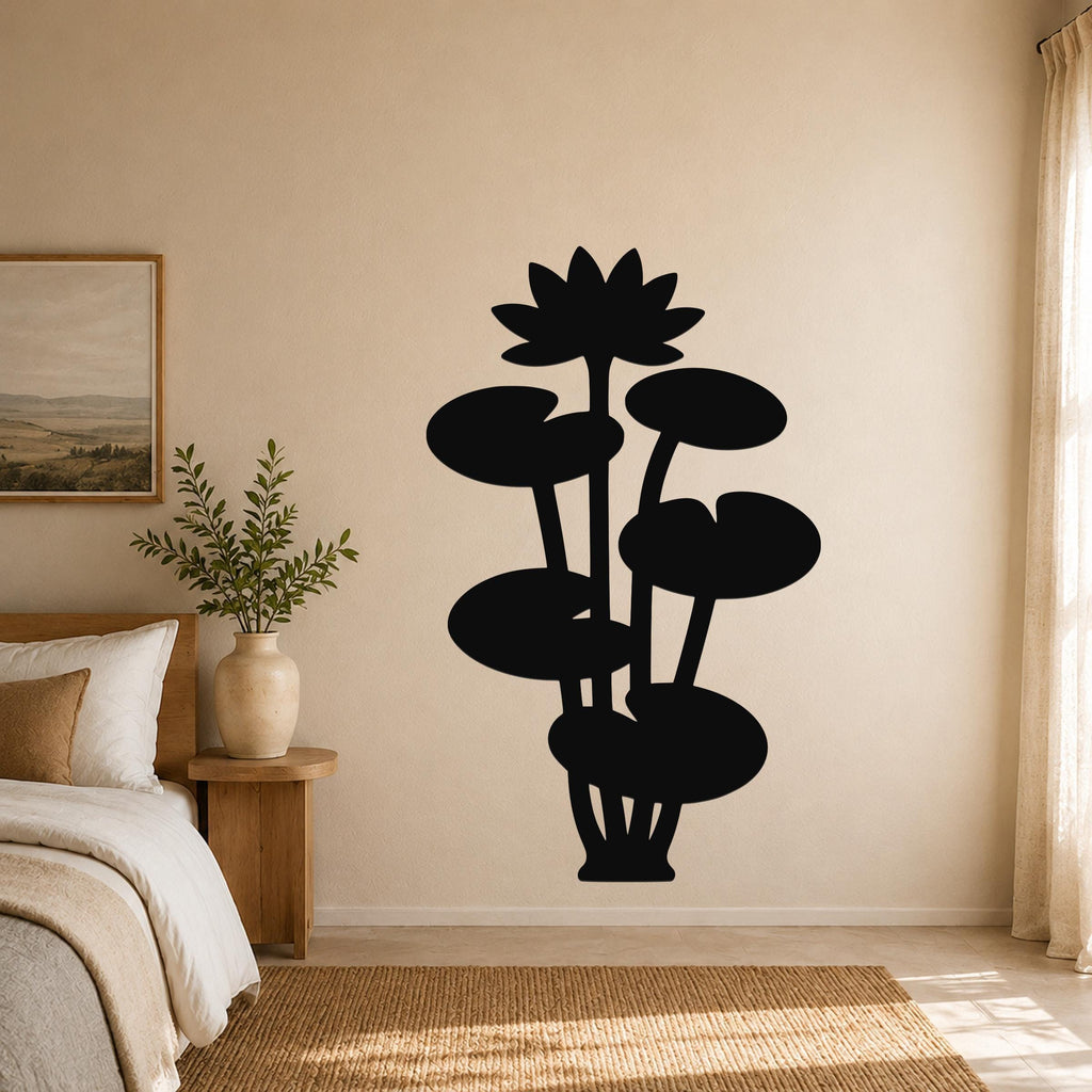 Black metal lotus water lily wall art with a silhouette design of flowers and leaves, mounted on a wall in a bedroom above a bed.