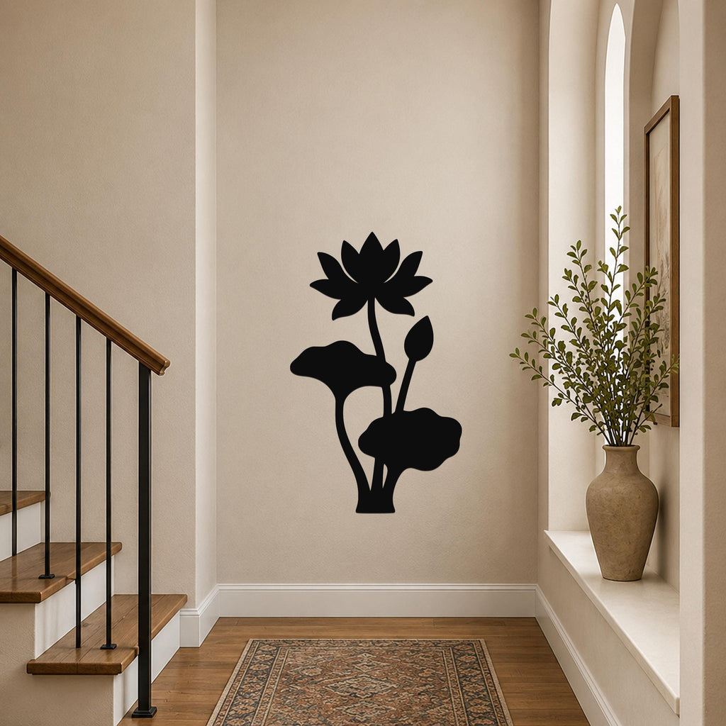 Black metal lotus flower wall art with leaf and bud cutouts, mounted on a hallway wall above a patterned rug near a staircase.