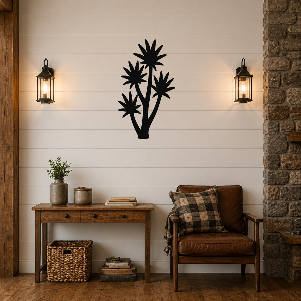 Black metal yucca wall art with multiple star-shaped leaf cutouts, mounted on a shiplap wall above a wooden console table in a living room.
