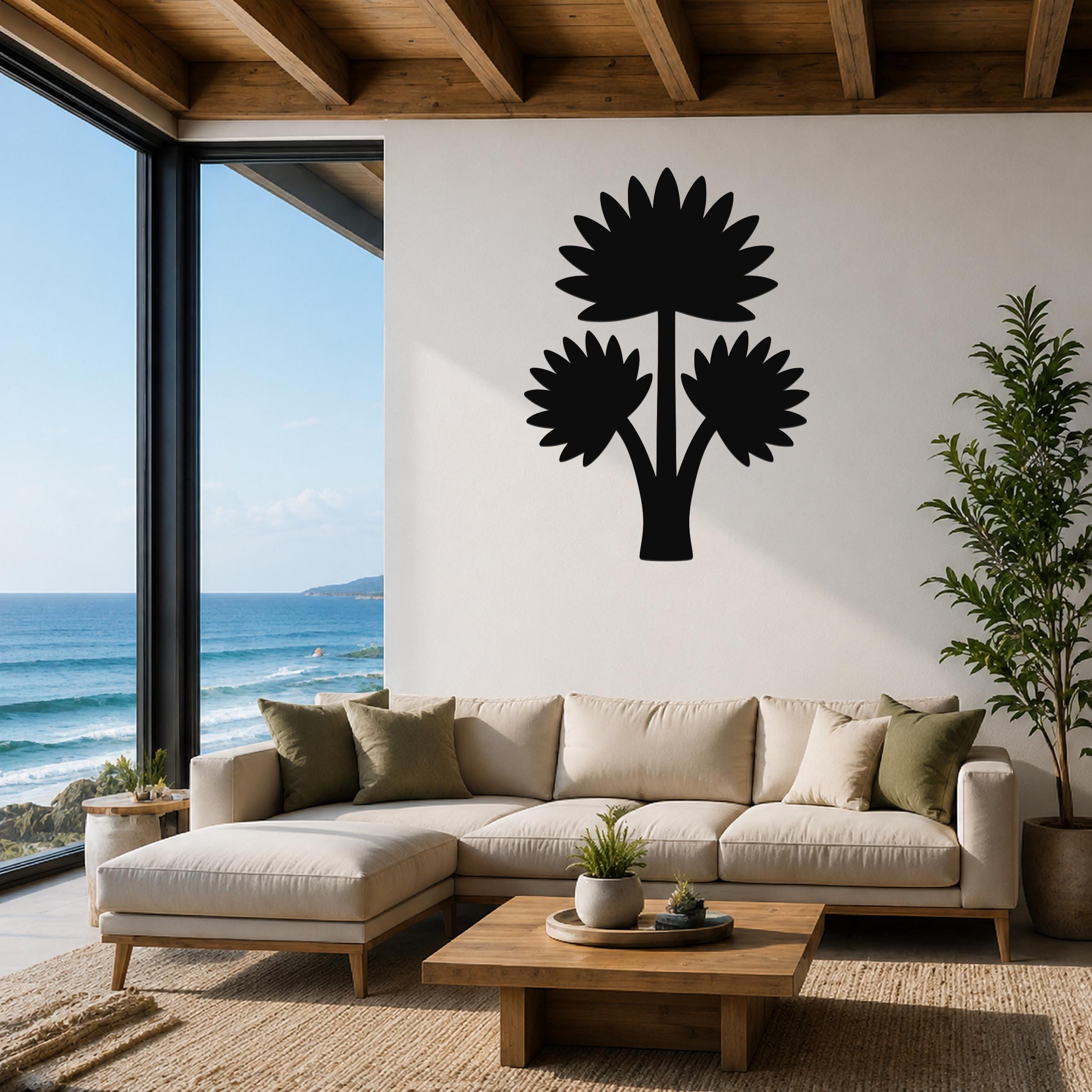 Black metal wall art in a fan palm tree silhouette, mounted on a white living room wall above a beige sectional sofa.