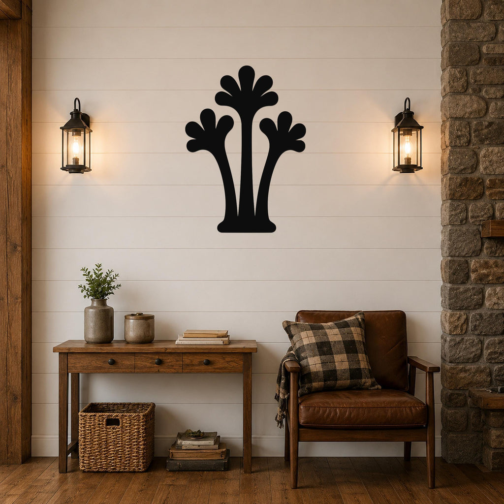 Black metal palm tree wall art with three fronded silhouettes, mounted on a shiplap wall above a wooden console table in a living room.