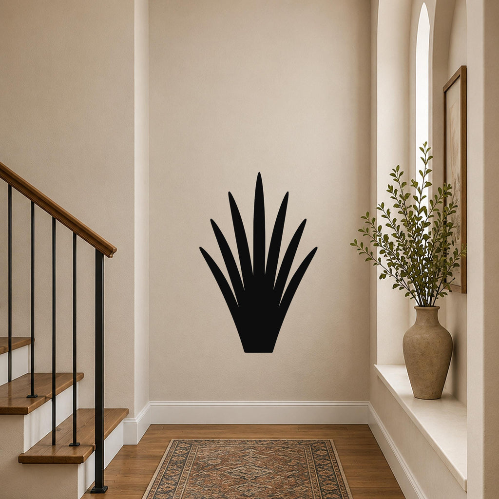 Black metal yucca plant wall art with spiky leaf cutouts, mounted on a beige hallway wall above a patterned rug.
