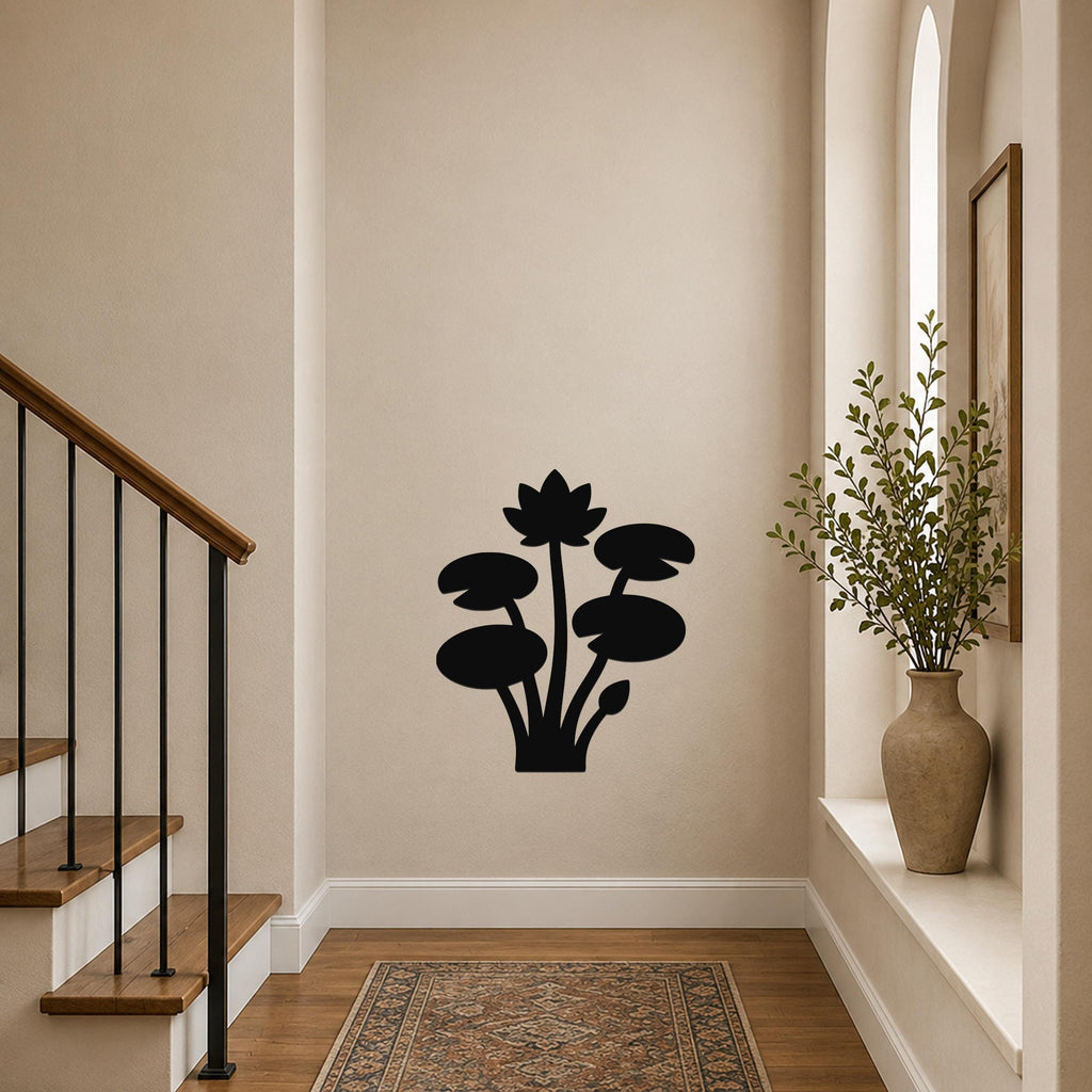 Black metal wall art silhouette of a lotus and water lily plant, mounted on a hallway wall above a patterned rug near a staircase.
