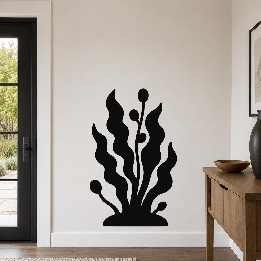 Black metal wall art in a kelp and seaweed silhouette design, mounted on a living room wall above a wooden console table.