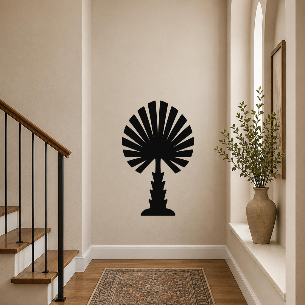 Black metal palm tree wall art with fan-shaped fronds, mounted on a hallway wall above a patterned rug near a staircase.