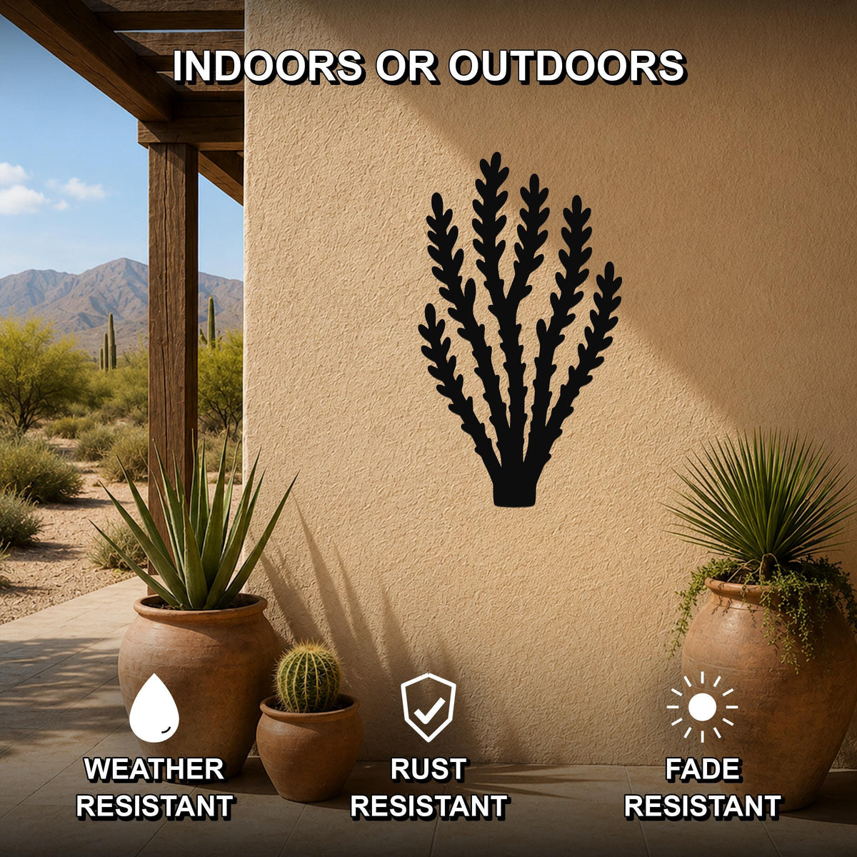Black metal wall art in a desert branch silhouette, mounted on an outdoor patio wall above potted plants, weather, rust, and fade resistant.