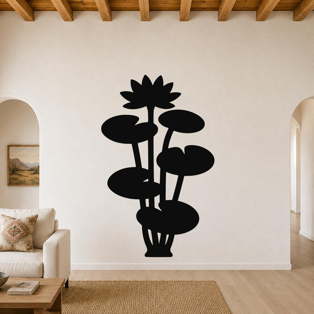 Black metal lotus water lily wall art with a silhouette design of flowers and leaves, mounted on a living room wall above a sofa.