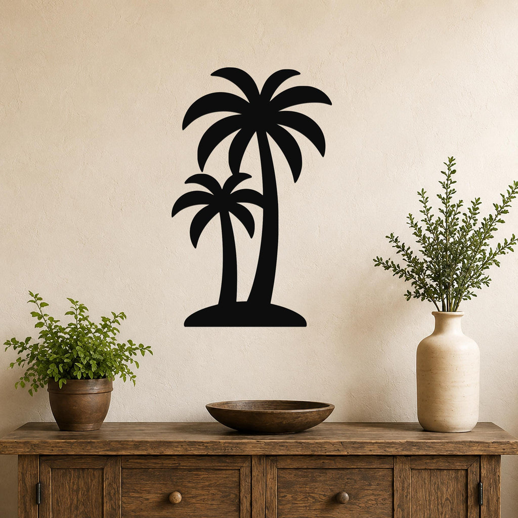 Black metal wall art featuring a silhouette of two palm trees, mounted on a beige wall above a wooden console table with potted plants.