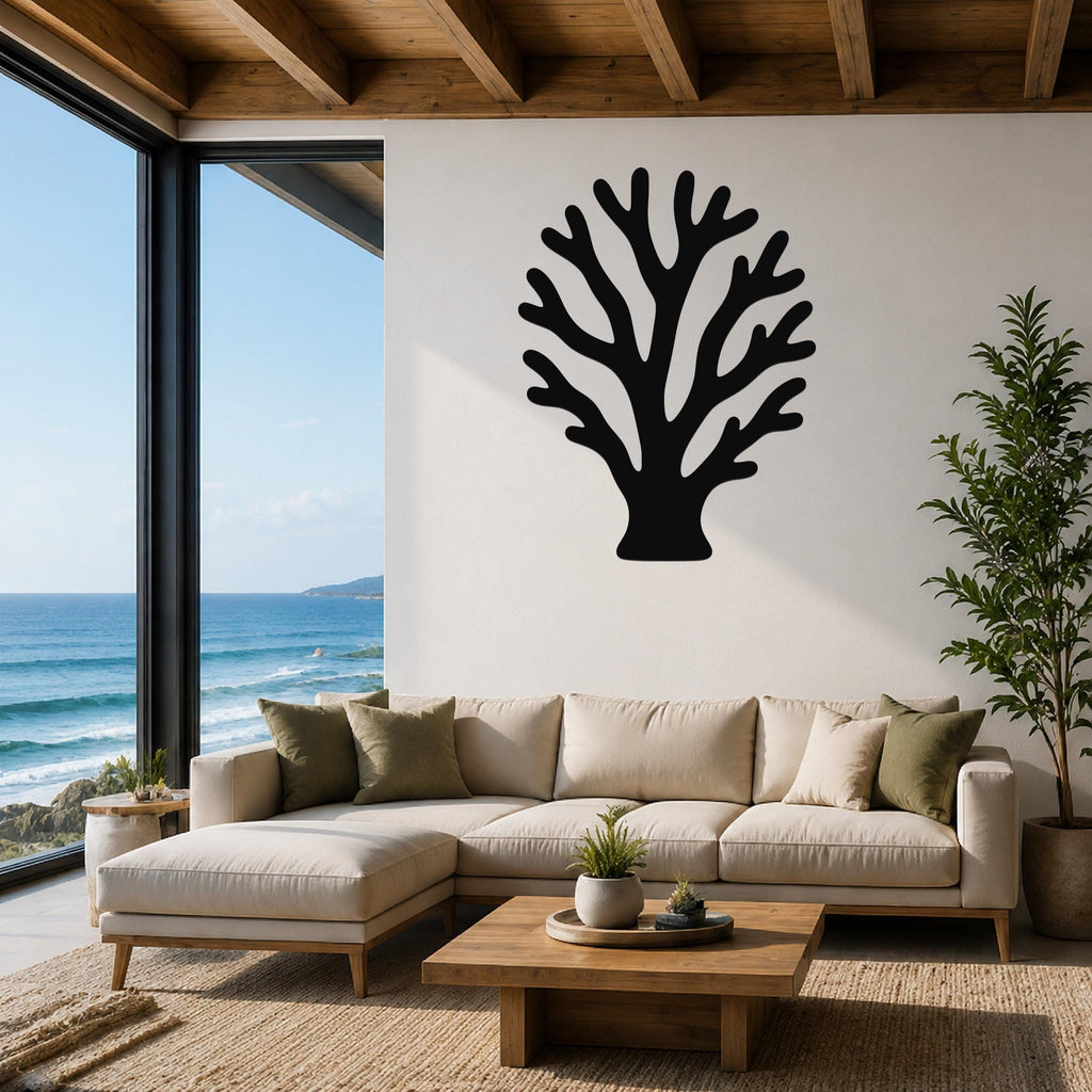 Black metal branching coral wall art with intricate cutout details, mounted on a white living room wall above a beige sectional sofa.
