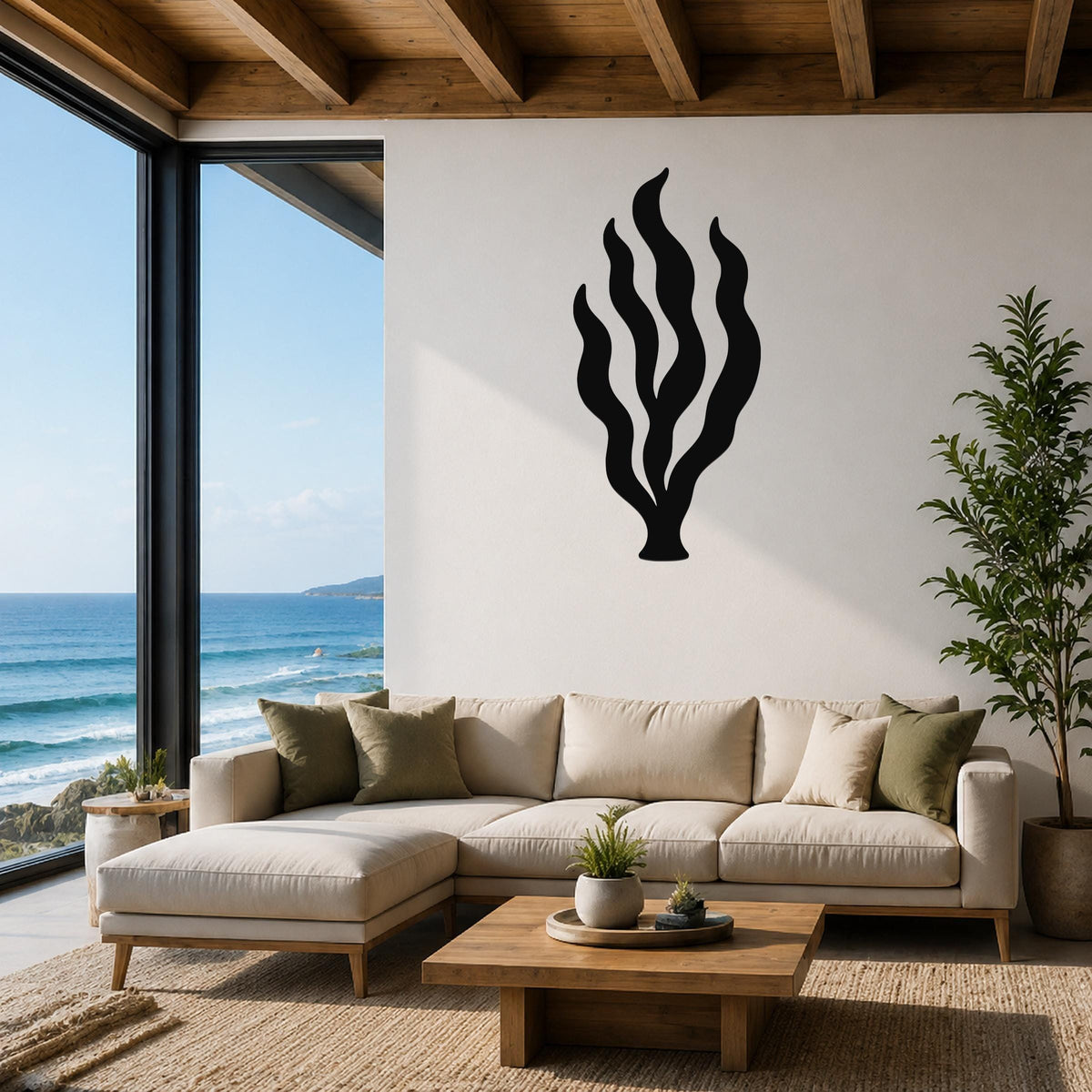 Black metal kelp seaweed wall art with flowing frond cutouts, mounted on a white wall above a beige sofa in a coastal living room.