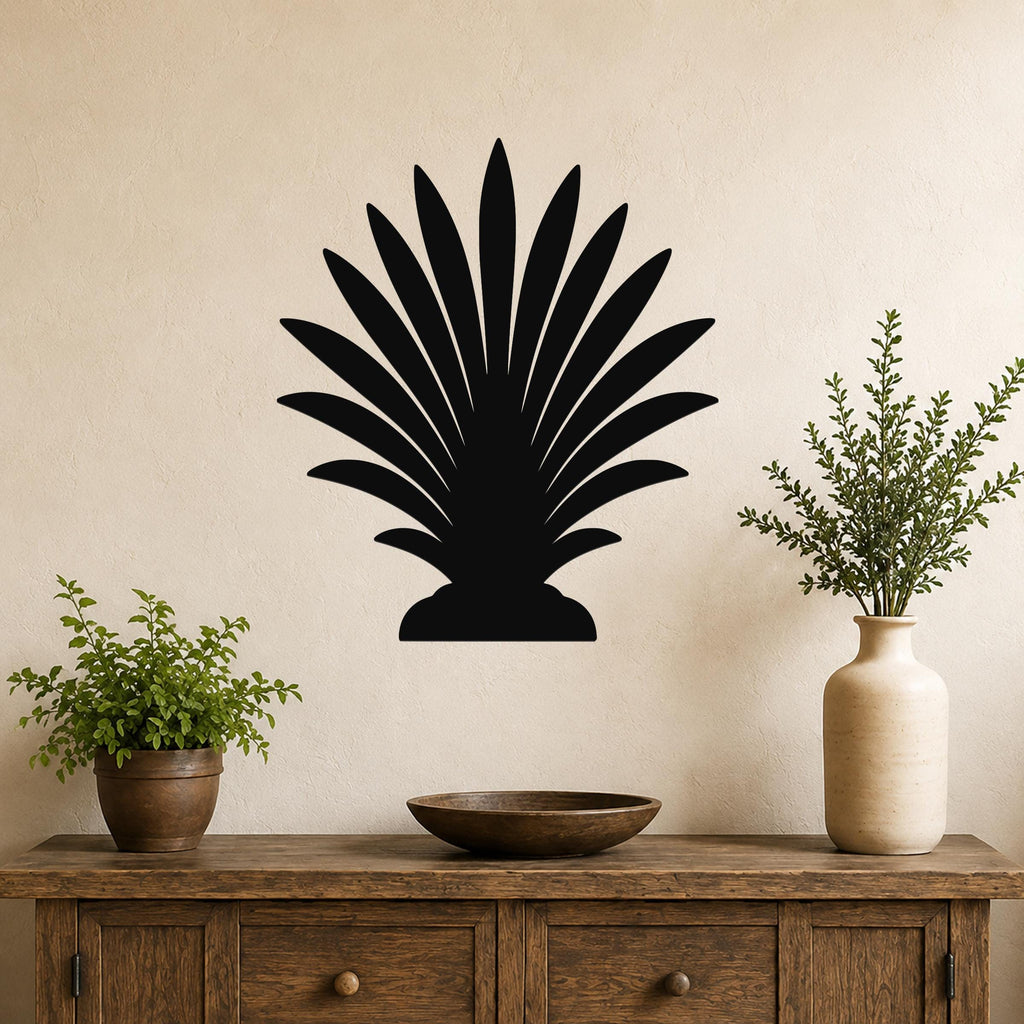 Black metal palm tree wall art with fan-shaped fronds, mounted on a beige wall above a wooden console table.