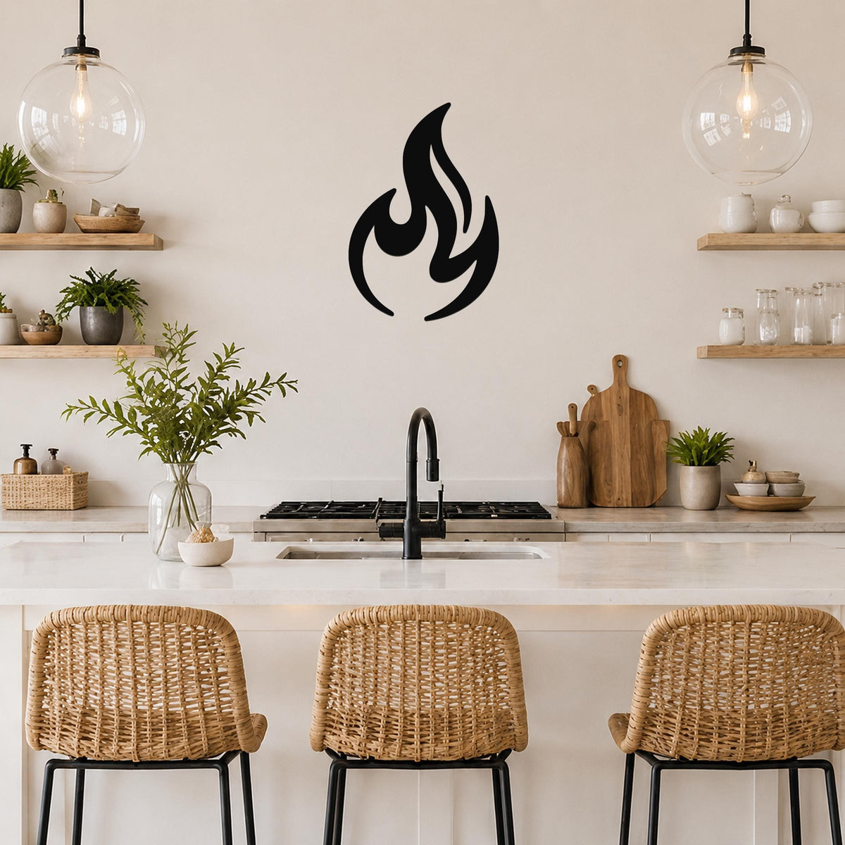 Black metal flame silhouette wall art with bold, flowing cutouts, mounted on a kitchen wall above a counter between two glass pendant lights.