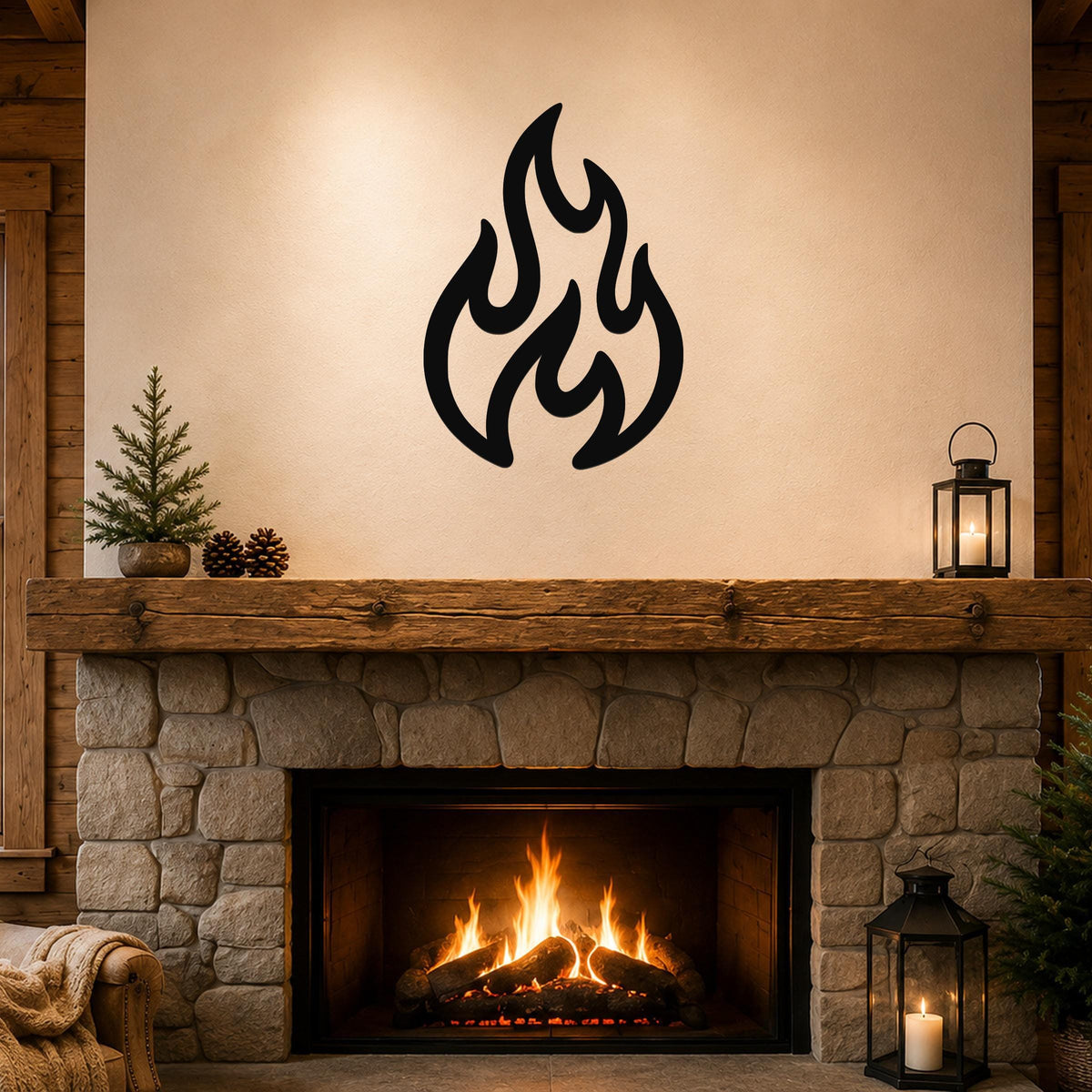Black metal flame wall art with flowing, abstract cutout shapes, mounted above a stone fireplace in a rustic living room.