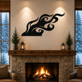 Black metal flame wall art with flowing swirl cutouts, mounted above a stone fireplace in a cozy living room.