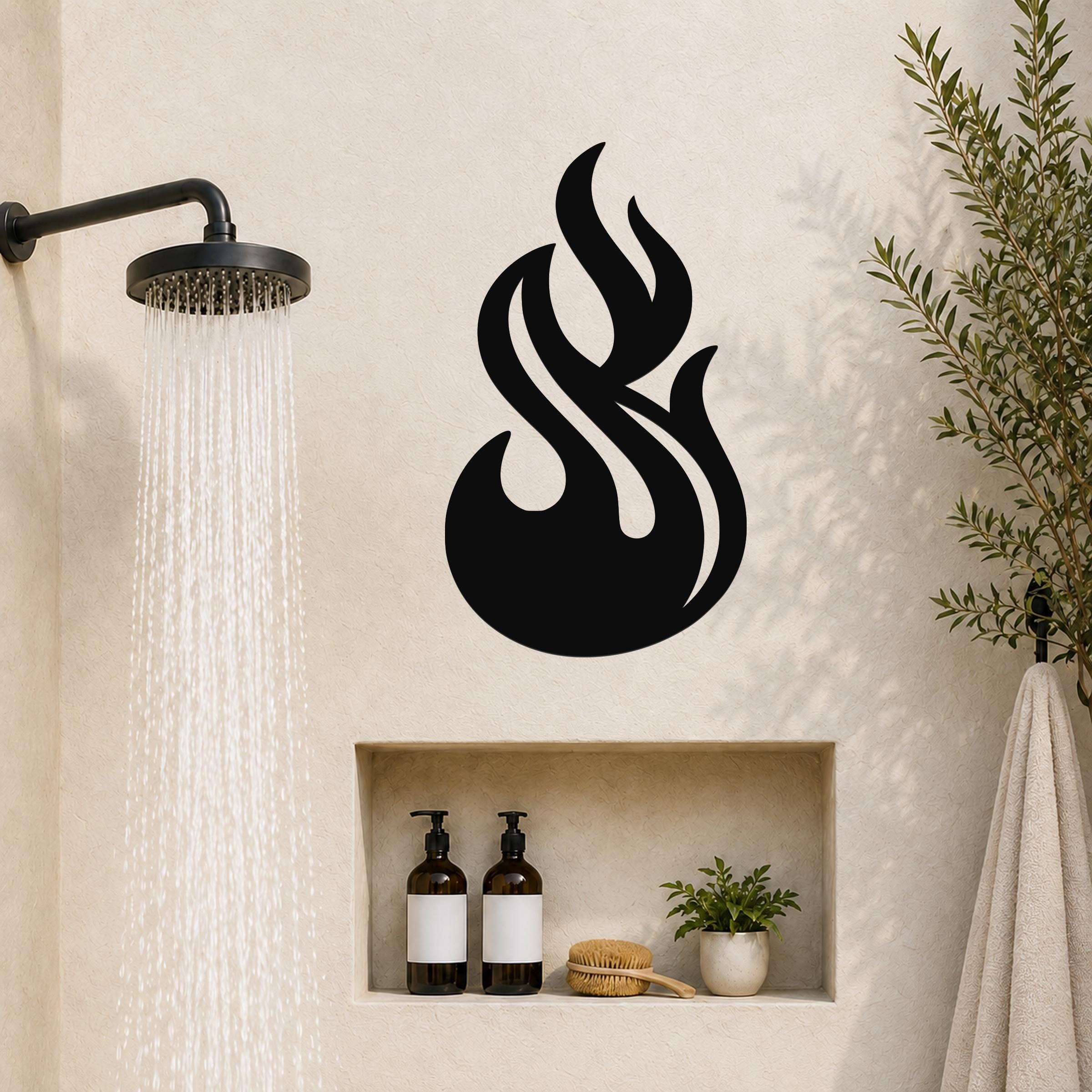 Black metal flame wall art with fluid, layered cutouts, mounted on a bathroom wall above a built-in shelf near a shower.